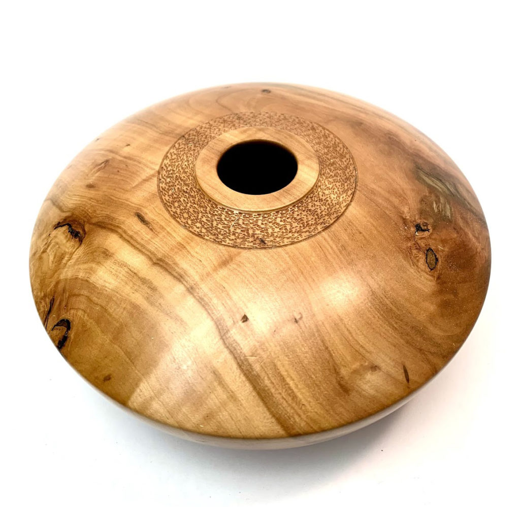 Photo of a turned vessel made from apple wood, with a narrow opening