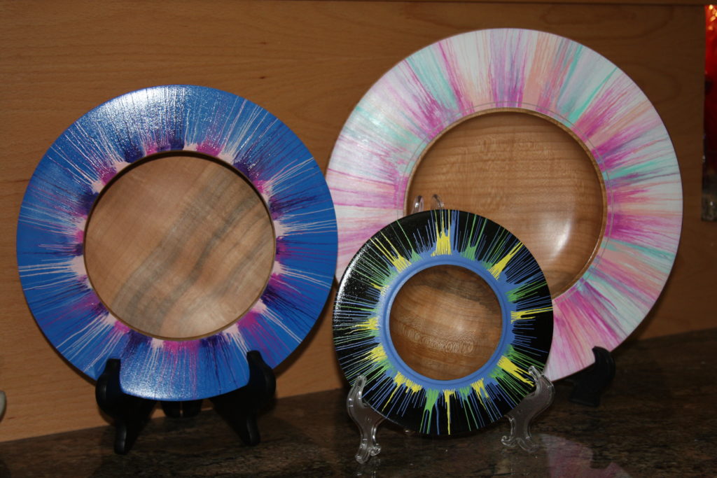 Three wide turned wood bowls with wide painted rims